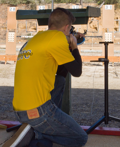 air rifle match competitor shooting kneeling stage