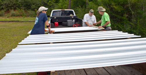 cutting metal to put up on the building