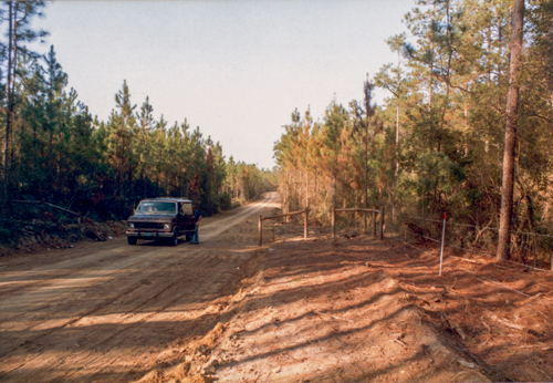 a van on the range road beside the new fence