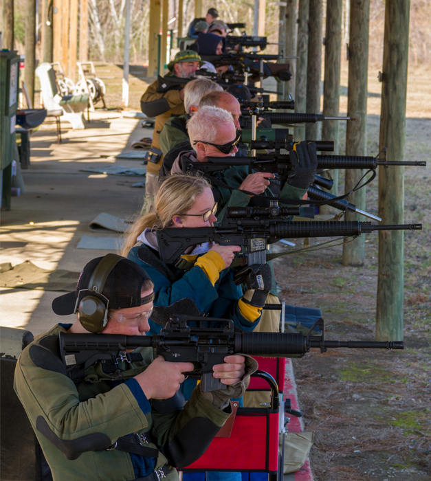 large competitor group shooting standing stage