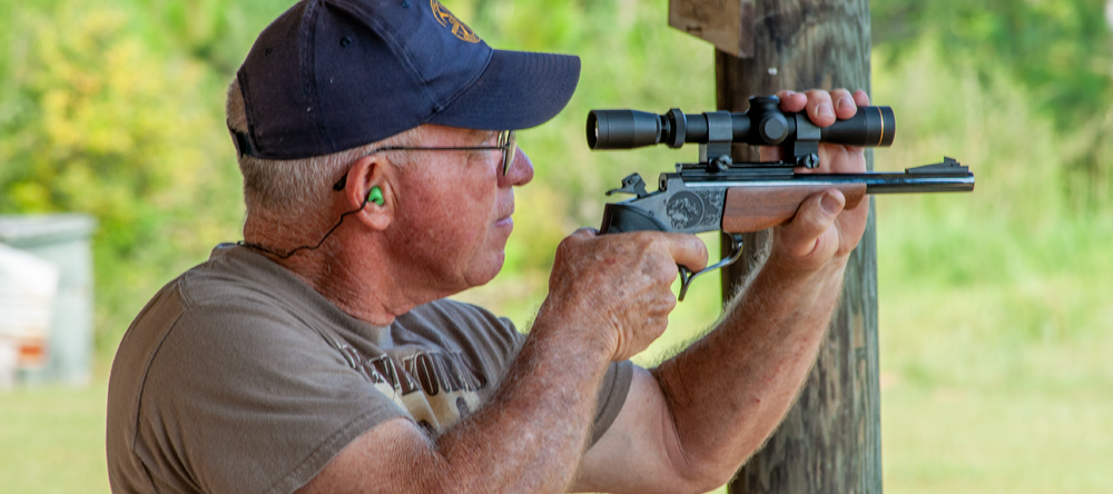 action image of male shooting pistol silhouette